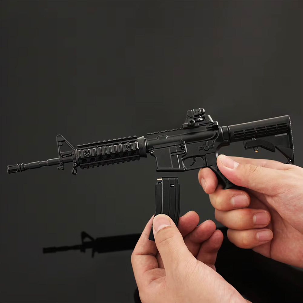 AR‑15 1:3 scale miniature rifle with magazine being inserted by hands on black background, showing realistic details and adjustable stock